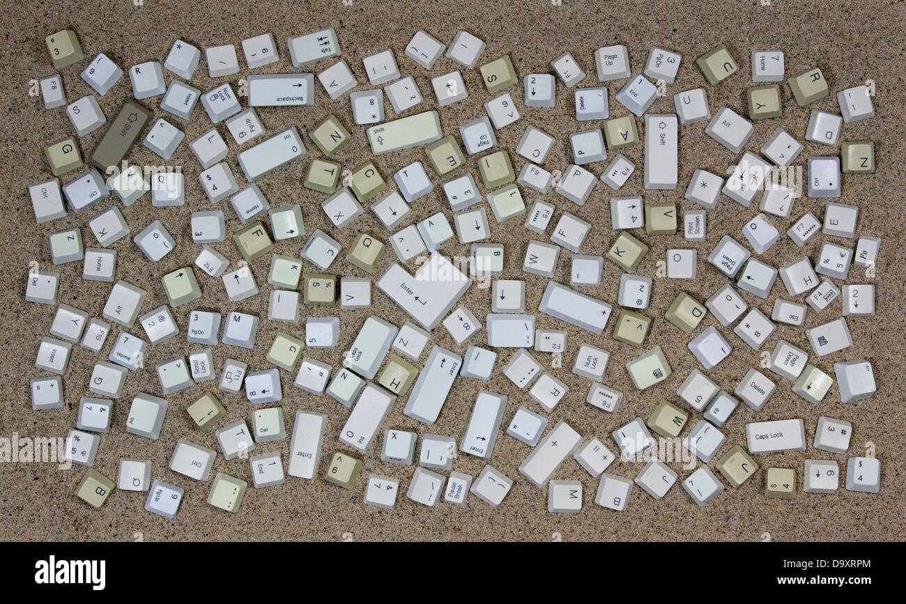 Computer keys over sand Stock Photo