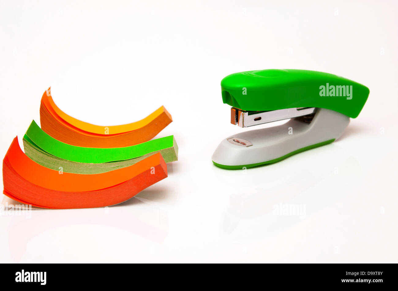 stapler with colored paper on a white background Stock Photo