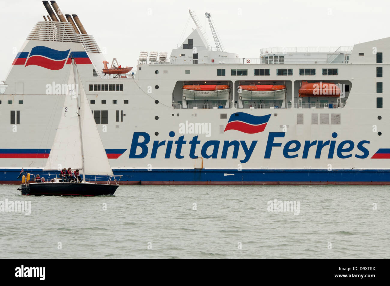 Brittany Ferries, Mont St Michel with a small yacht sailing past Stock