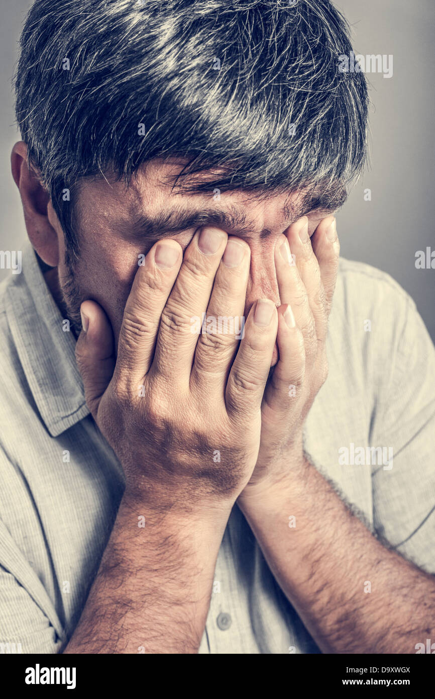 man covered his face with his hands Stock Photo - Alamy