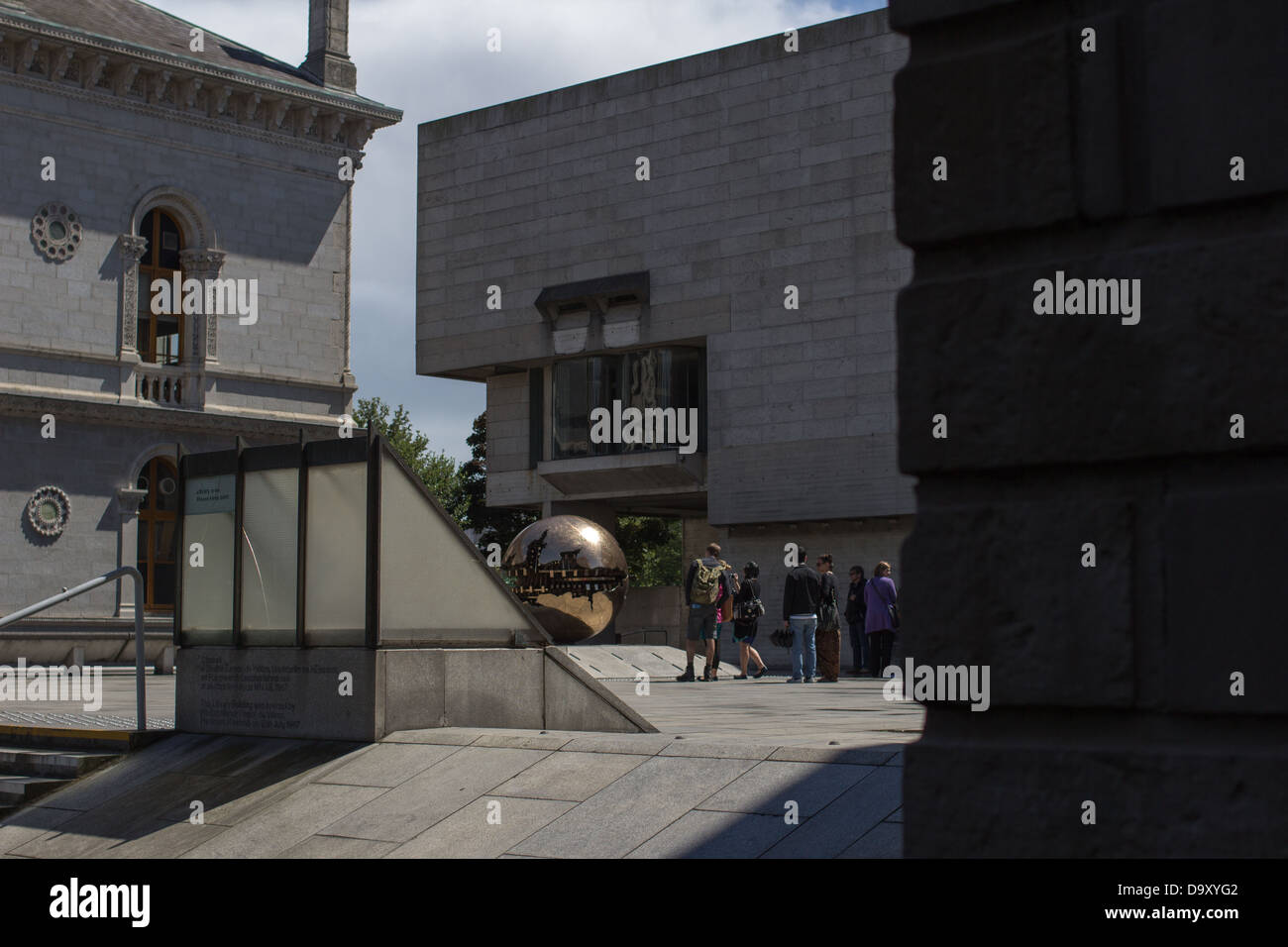 Visitors/students to the Trinity College in Dublin in front of a sculpture. Stock Photo
