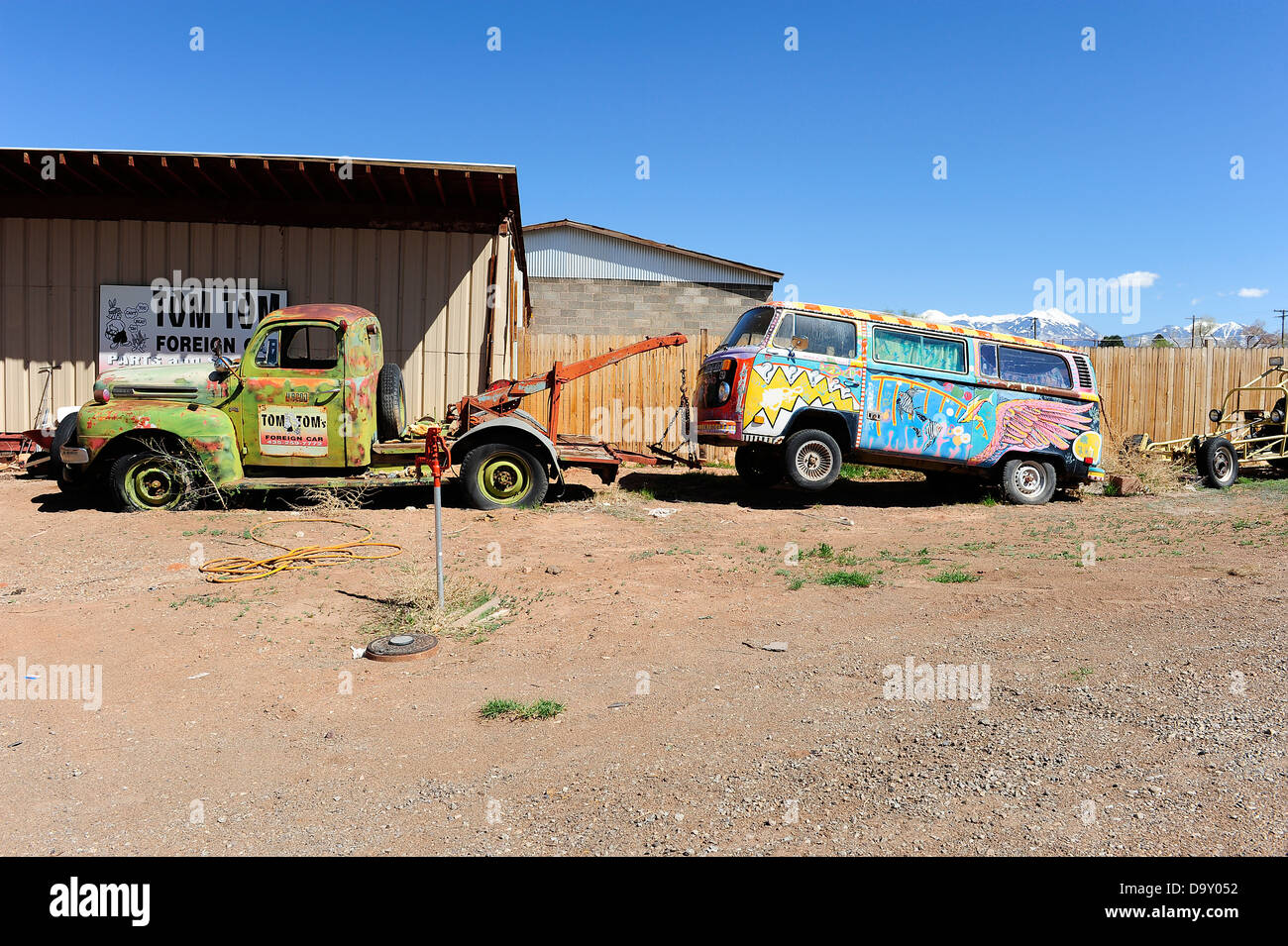 Painted Volkswagen camper van held up by breakdown truck, Moab, Utah, USA. Stock Photo