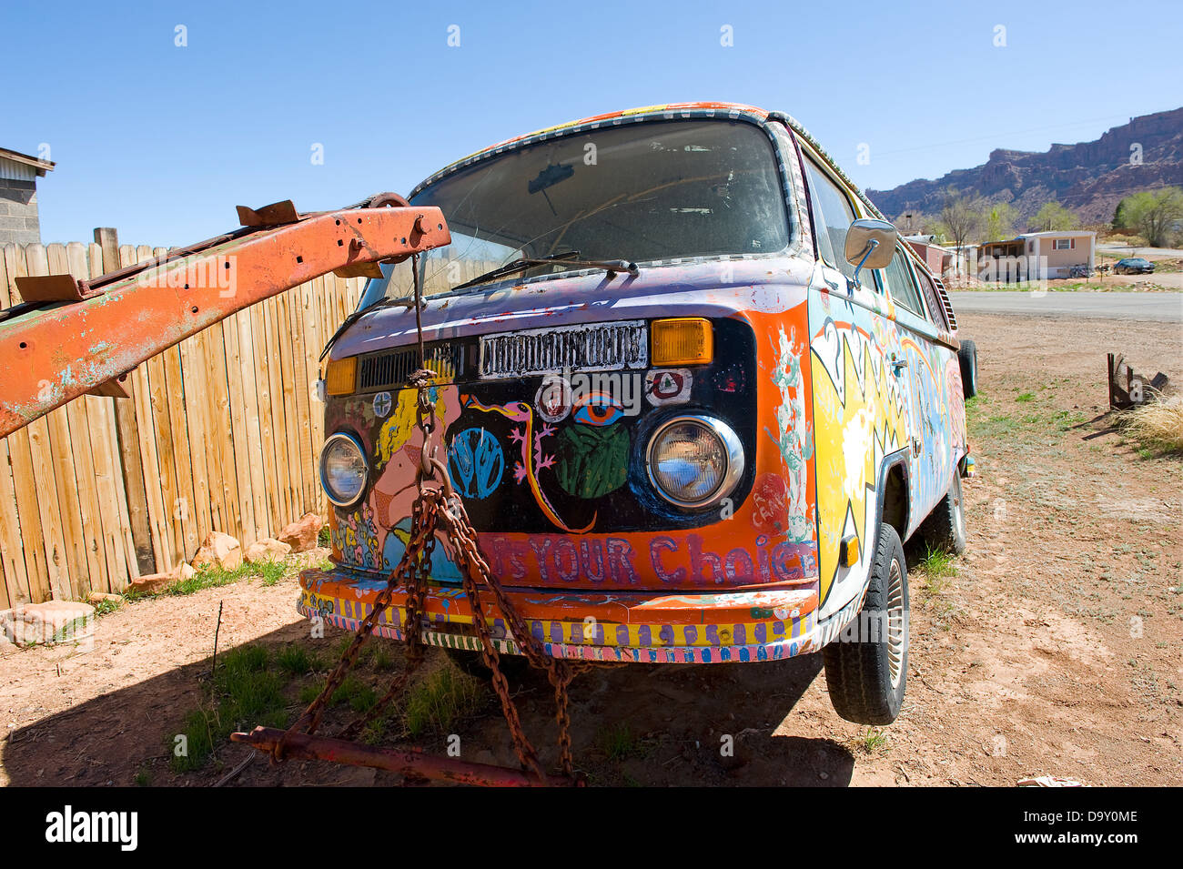 Painted Volkswagen camper van held up by breakdown truck, Moab, Utah, USA. Stock Photo