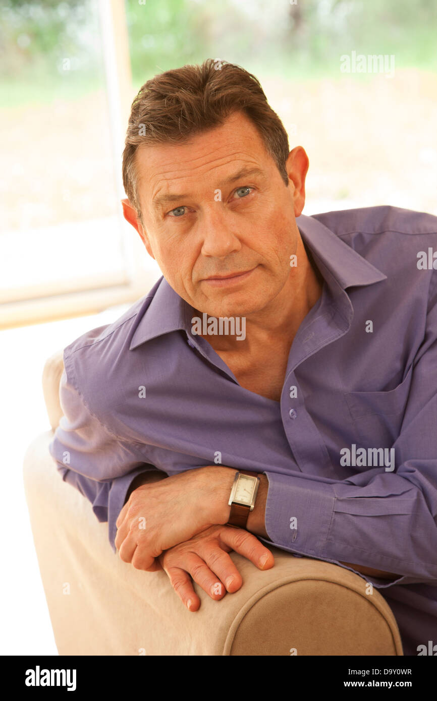 Portrait of a good looking middle aged man at home. Stock Photo