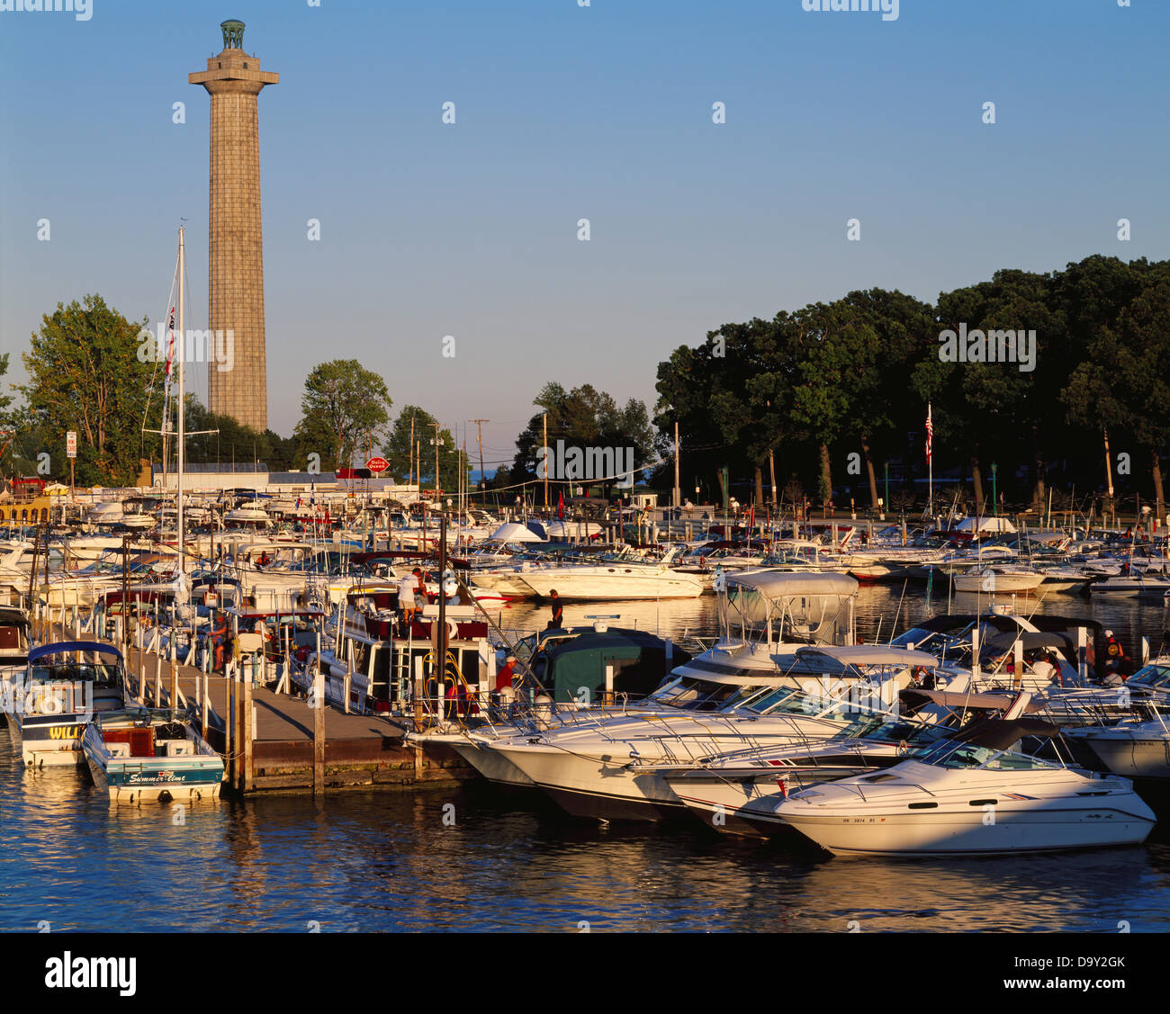 Boats docked Put-in-Bay with Perry's Victory International Peace Memorial rising 352 feet beyond South Bass Island Lake Erie Stock Photo