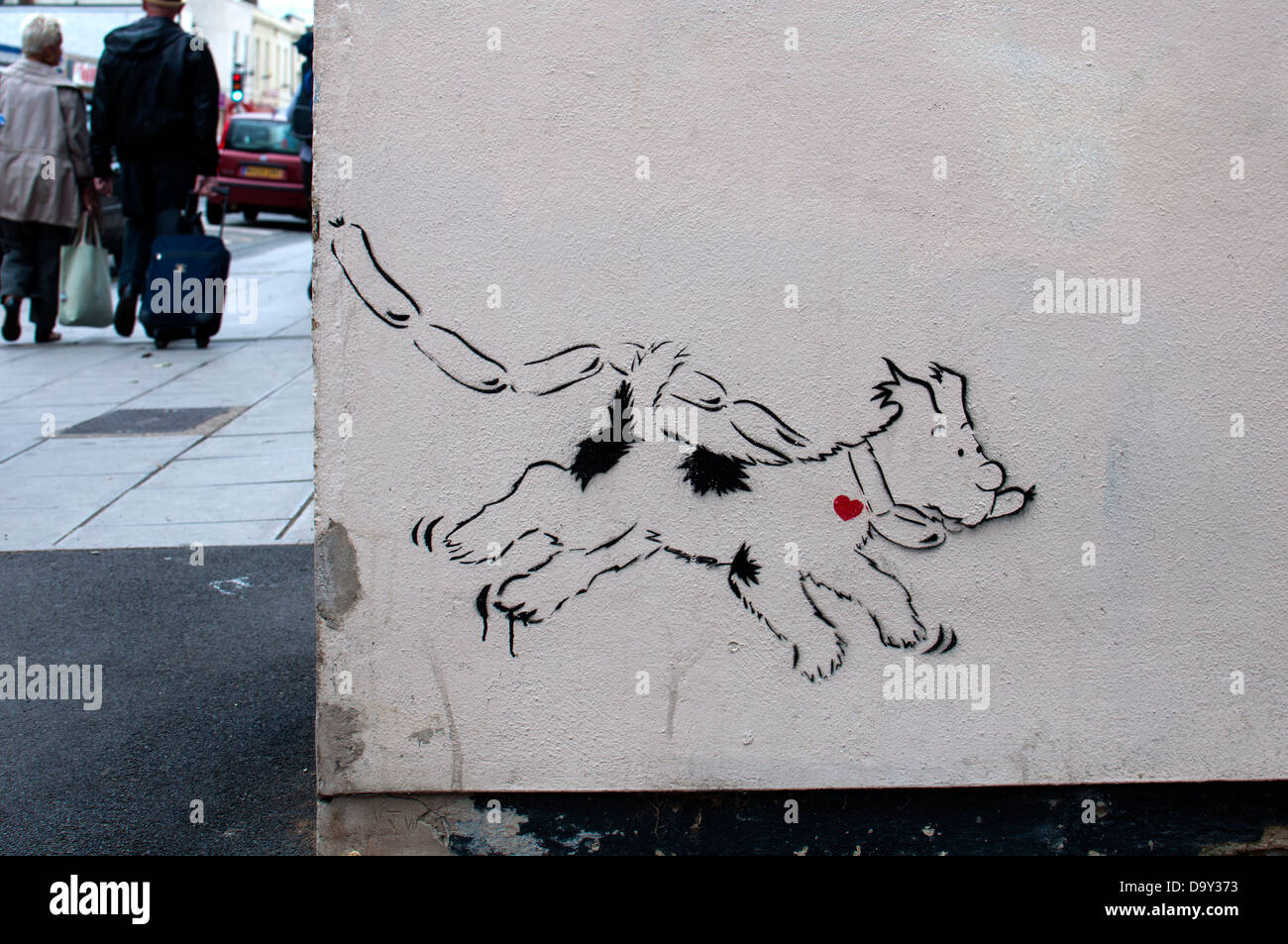 Dog with sausages Banksy, Cheltenham Spa, UK Stock Photo