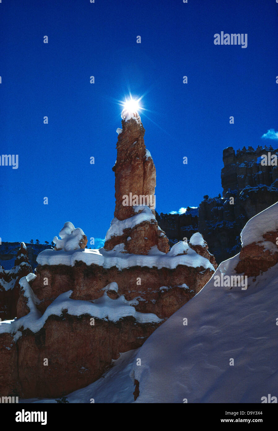 Sun backlighting Claron Formation hoodoo on Peek-a-boo Trail, Bryce Canyon National Park, Utah. Stock Photo