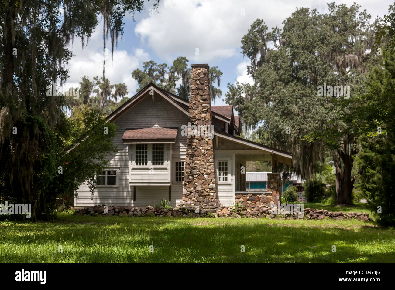 Craftsman bungalow with stone chimney and low retaining walls located
