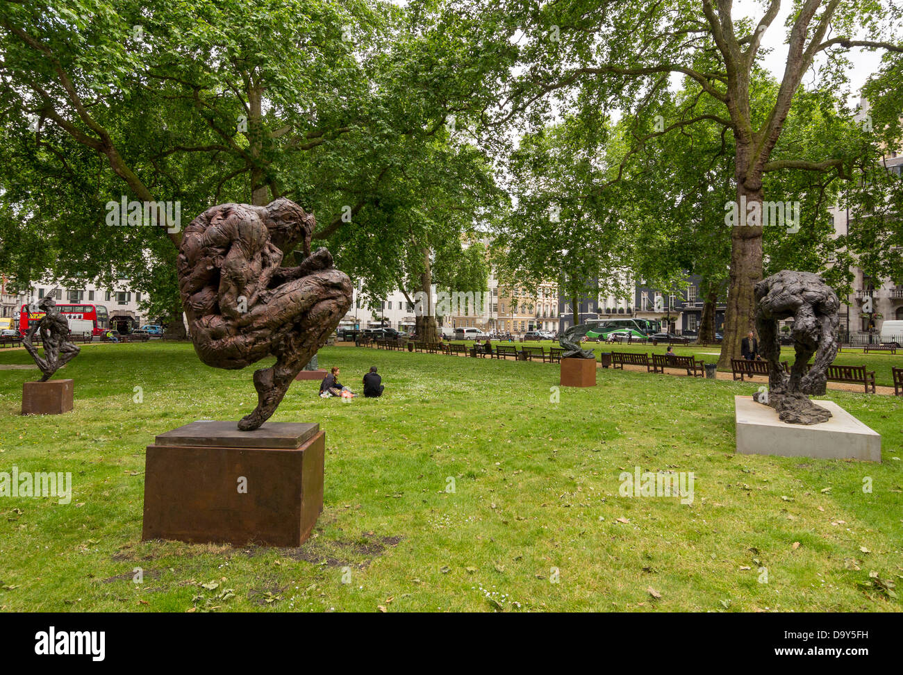 Sculptures in Berkeley Square, Mayfair, London. In the foreground a bronze artwork by Dylan Lewis Stock Photo