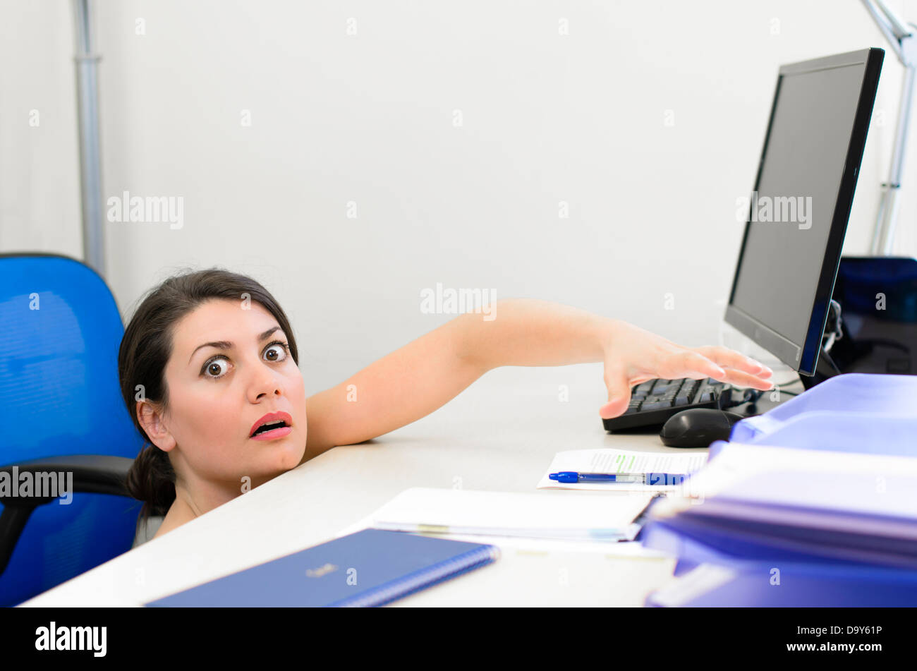 Business woman peeking over the desk Stock Photo