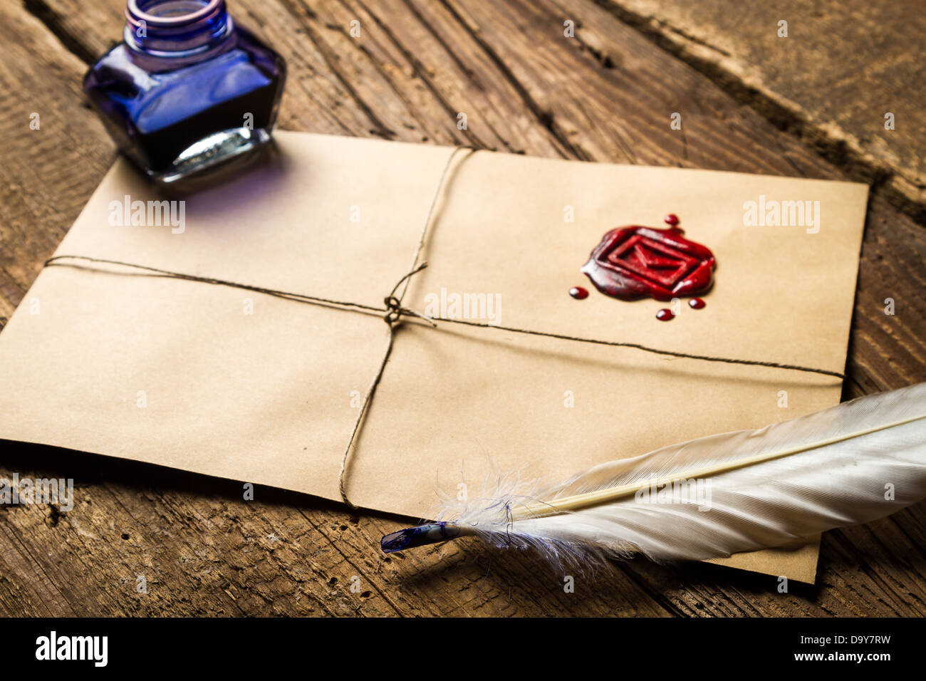 Old feather, envelope, sealing wax and ink bottle Stock Photo Alamy