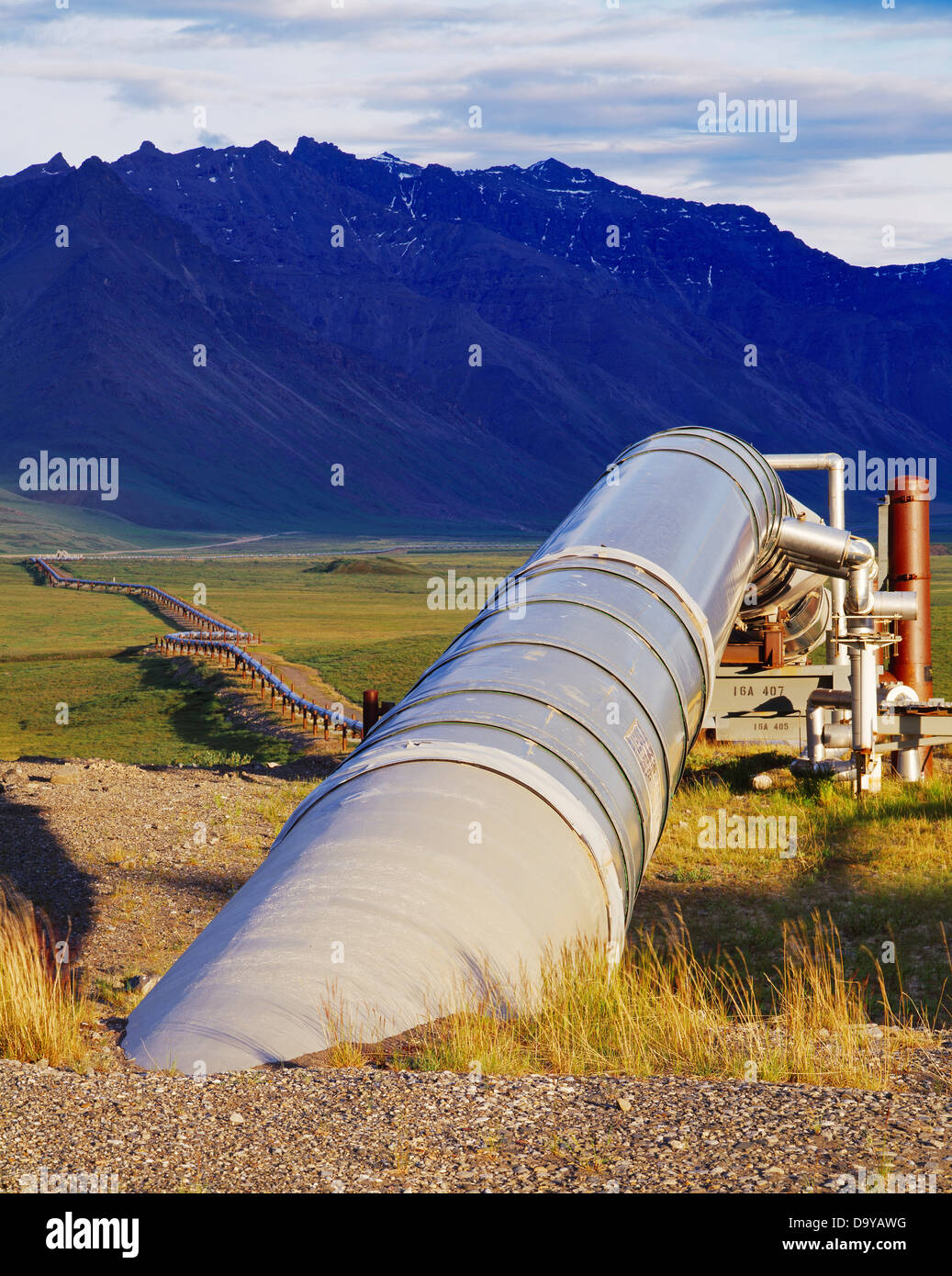 The Trans Alaska Pipeline leaving Pump Station 4 with the Philip Smith Mountains of the Brooks Range beyond, Alaska. Stock Photo