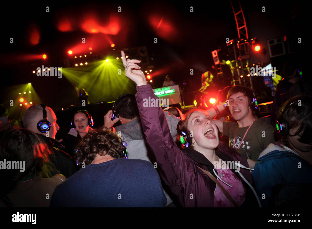 Glastonbury, UK. 28th June 2013. GLASTONBURY MUSIC FESTIVAL UK  2013 Festival goers wearing headphone in the Silent disco tent where you can only hear the songs through the headphones. GLASTONBURY MUSIC FESTIVAL PILTON, SOMERSET, ENGLAND, UK Credit:  Alistair Heap/Alamy Live News Stock Photo