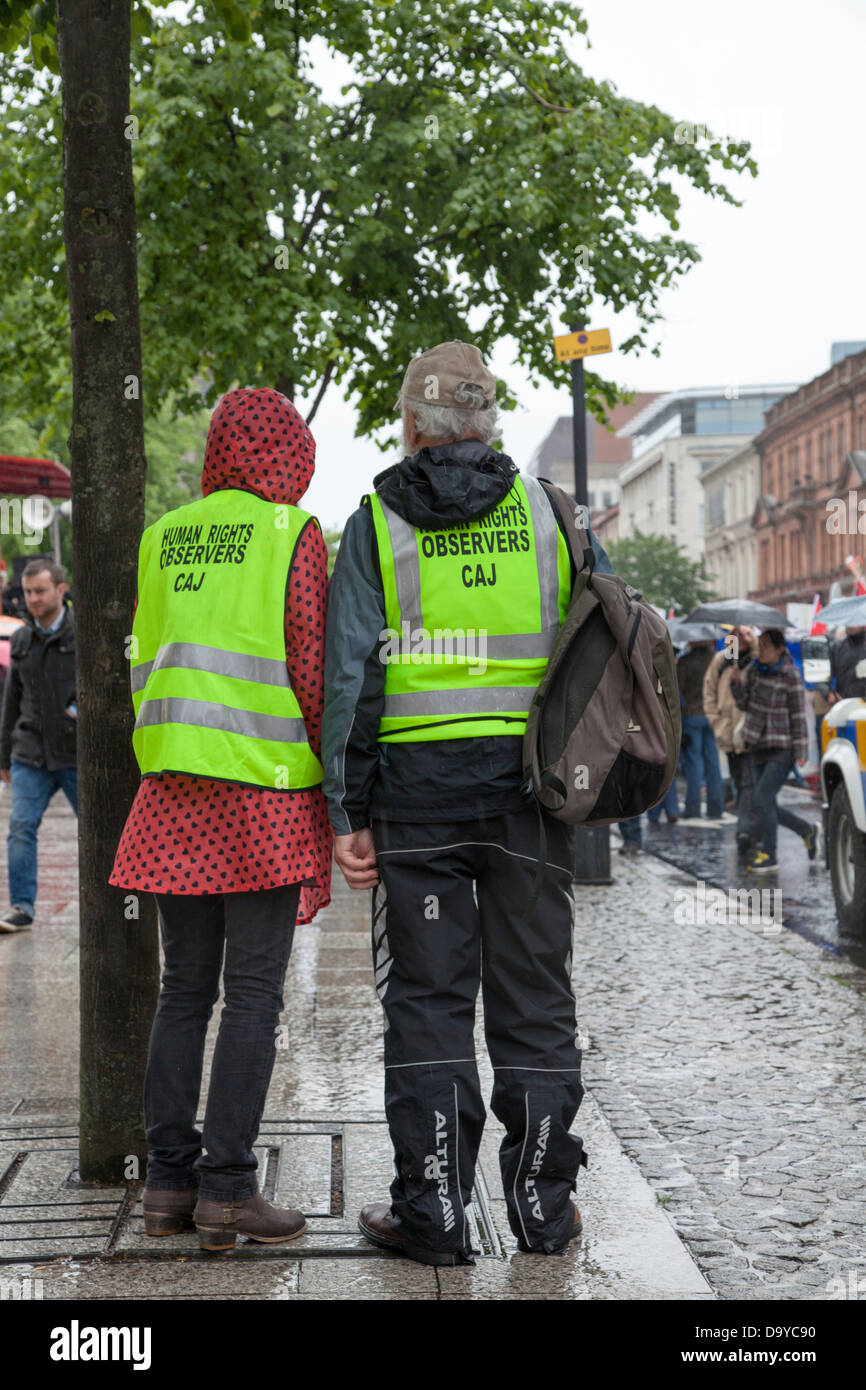 Observers from the Committee for the Administration of Justice watch events at an anti G8 protest in Belfast Stock Photo