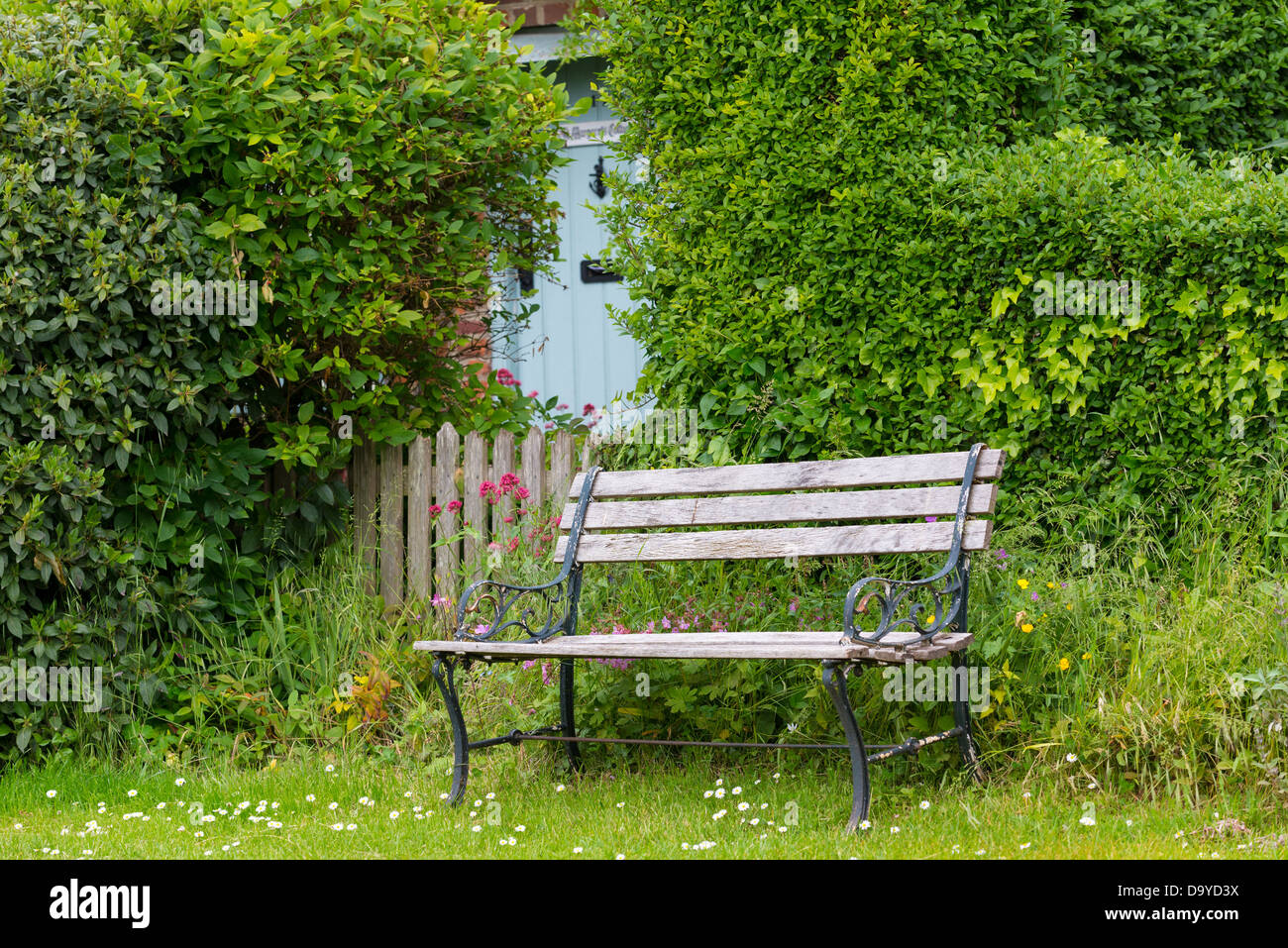 Country cottage view with garden seat, garden gate and front door, Norfolk, England. Stock Photo