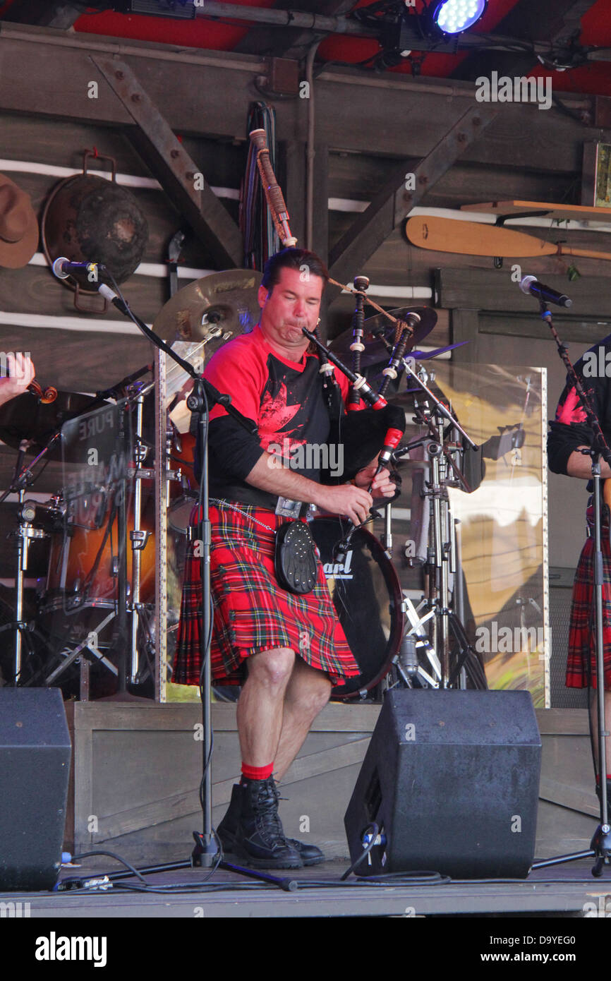 Scottish rock band with traditional costumes on stage at Epcot Center's ...