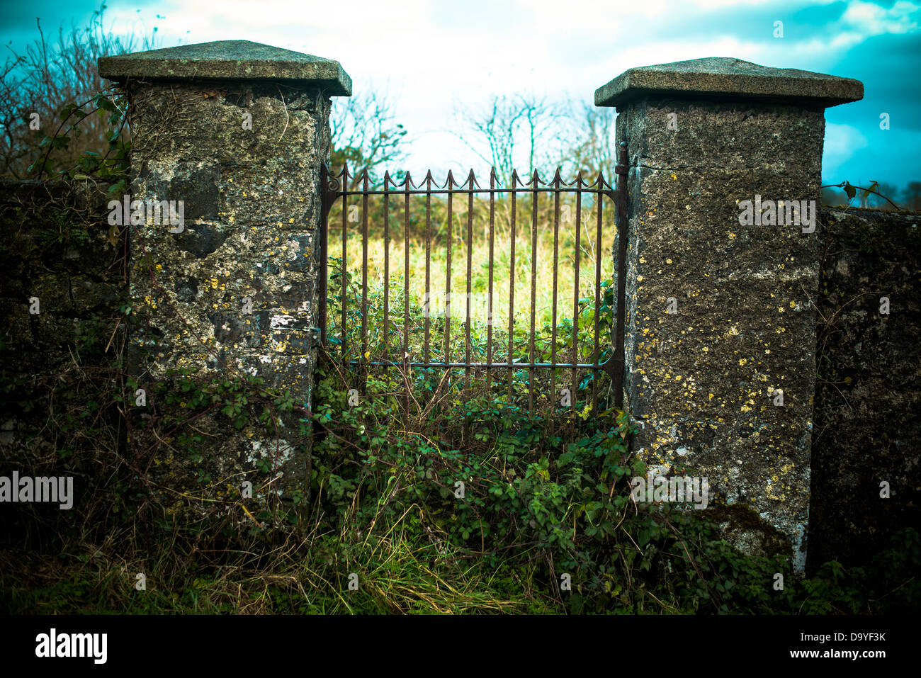 Old gate entrance to walled estate, with original wrought iron gate. Stock Photo