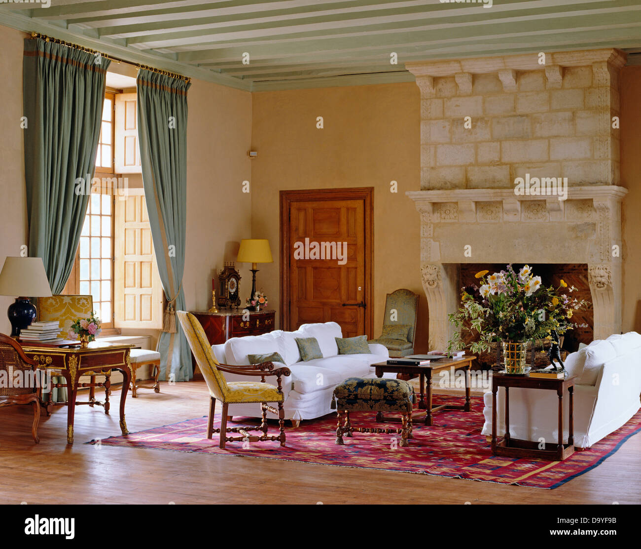 Comfortable White Sofas On Either Side Of Tall Stone Fireplace In