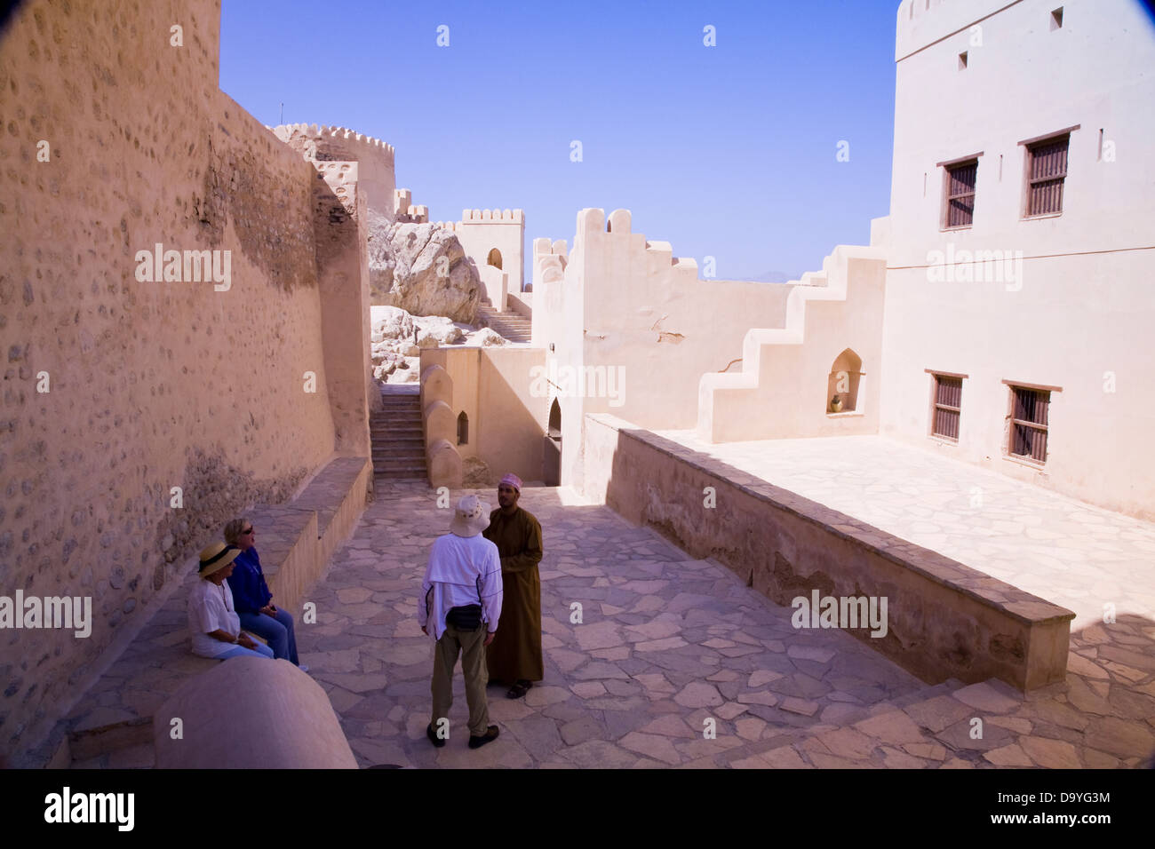 A tour group explores the well-preserved Fort of Nakhal, Nakhal, Oman Stock Photo