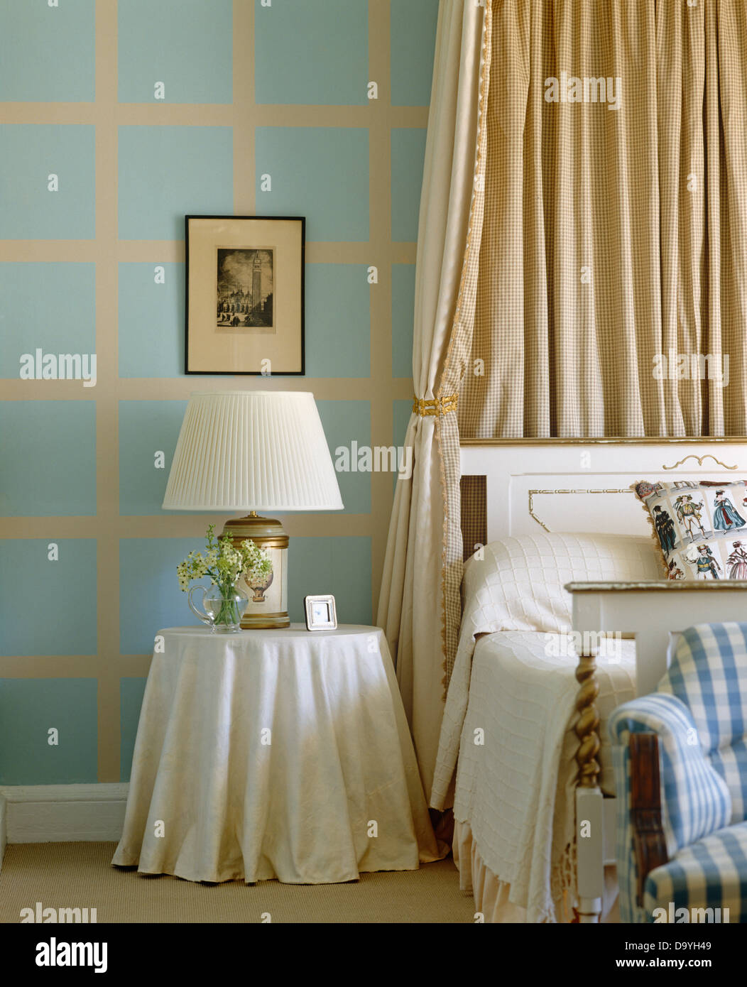 Beige Silk Drapes On Canopy Above Bed Beside Small Table With
