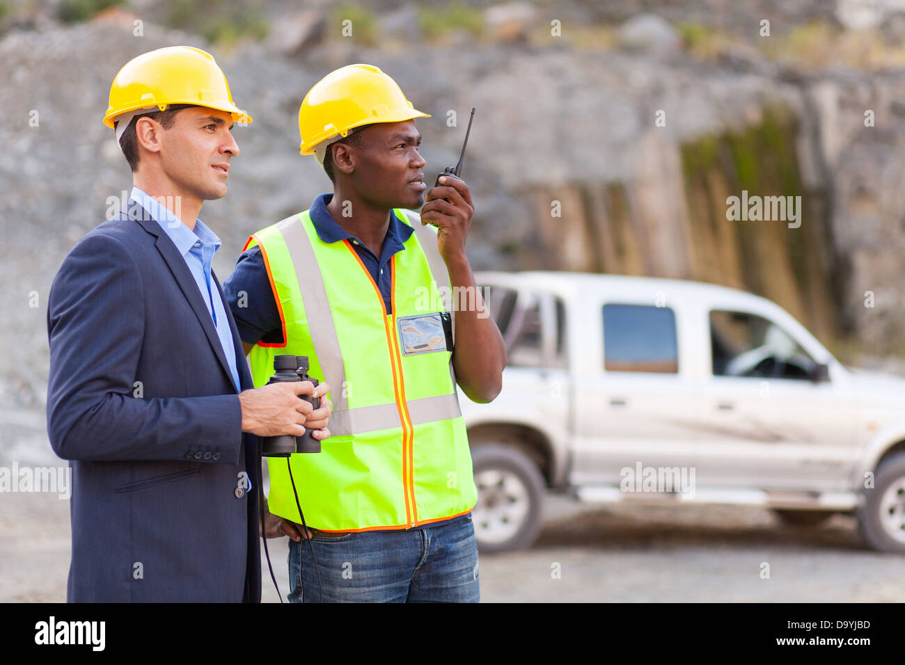 mine manager and worker visiting mining site Stock Photo