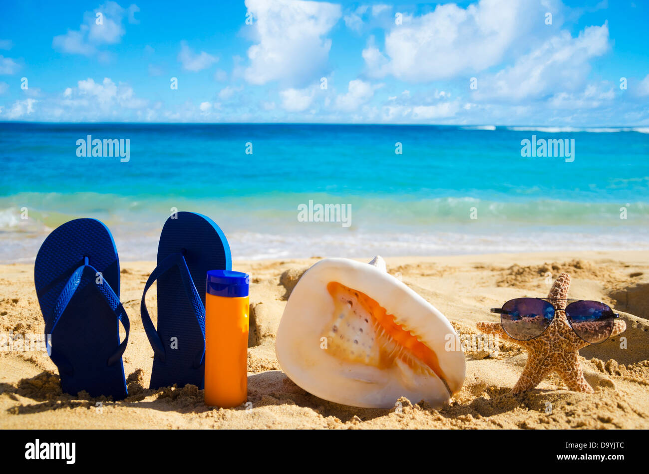 Blue Flip flops, seashell, sunscreen and starfish with sunglasses on ...