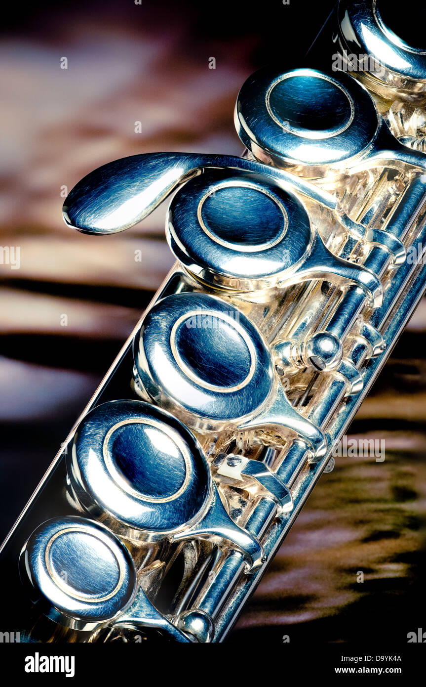 Close view of a segment of a silver flute. Stock Photo