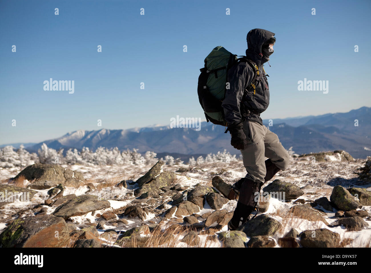 A climber descends from the summit of a peak in the White Mountains of New Hampshire. Stock Photo