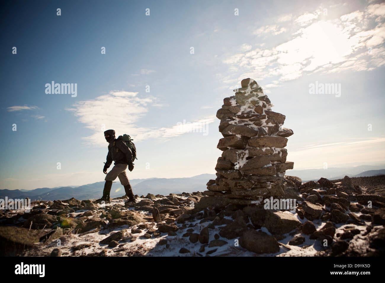 A mountaineer walks past a cairn on his way to the summit of Mount Moosilauke in the White Mountains of New Hampshire. Stock Photo