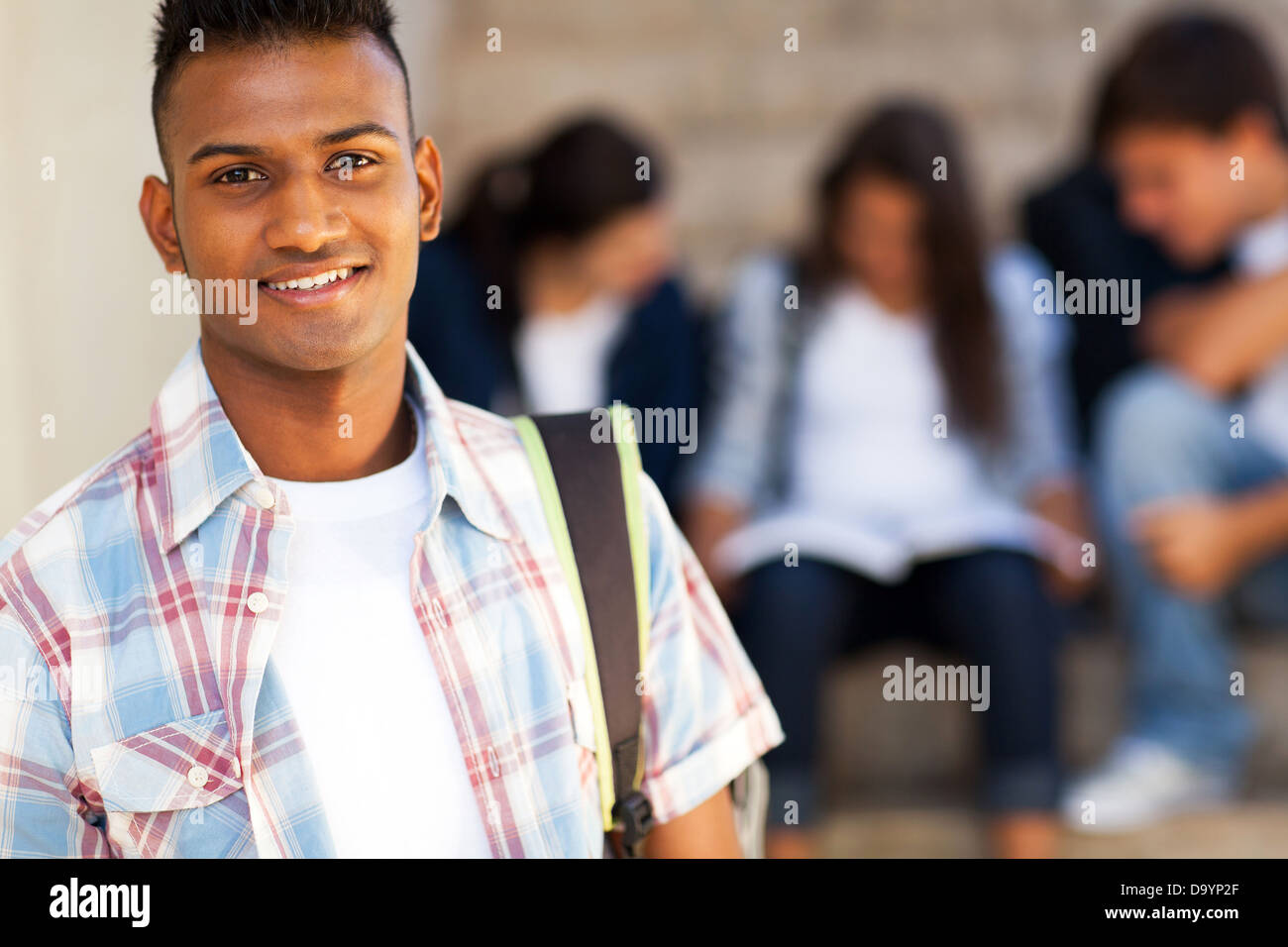 handsome Indian teenage high school student carrying schoolbag Stock Photo