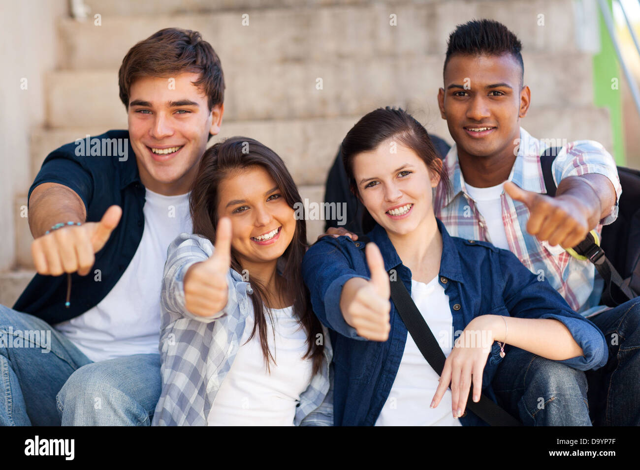 group smiling high school students giving thumbs up Stock Photo