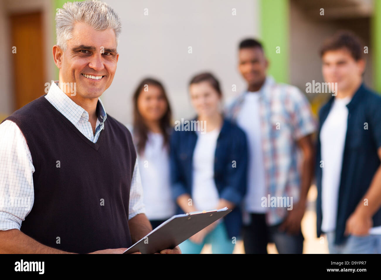 happy middle aged male high school teacher Stock Photo