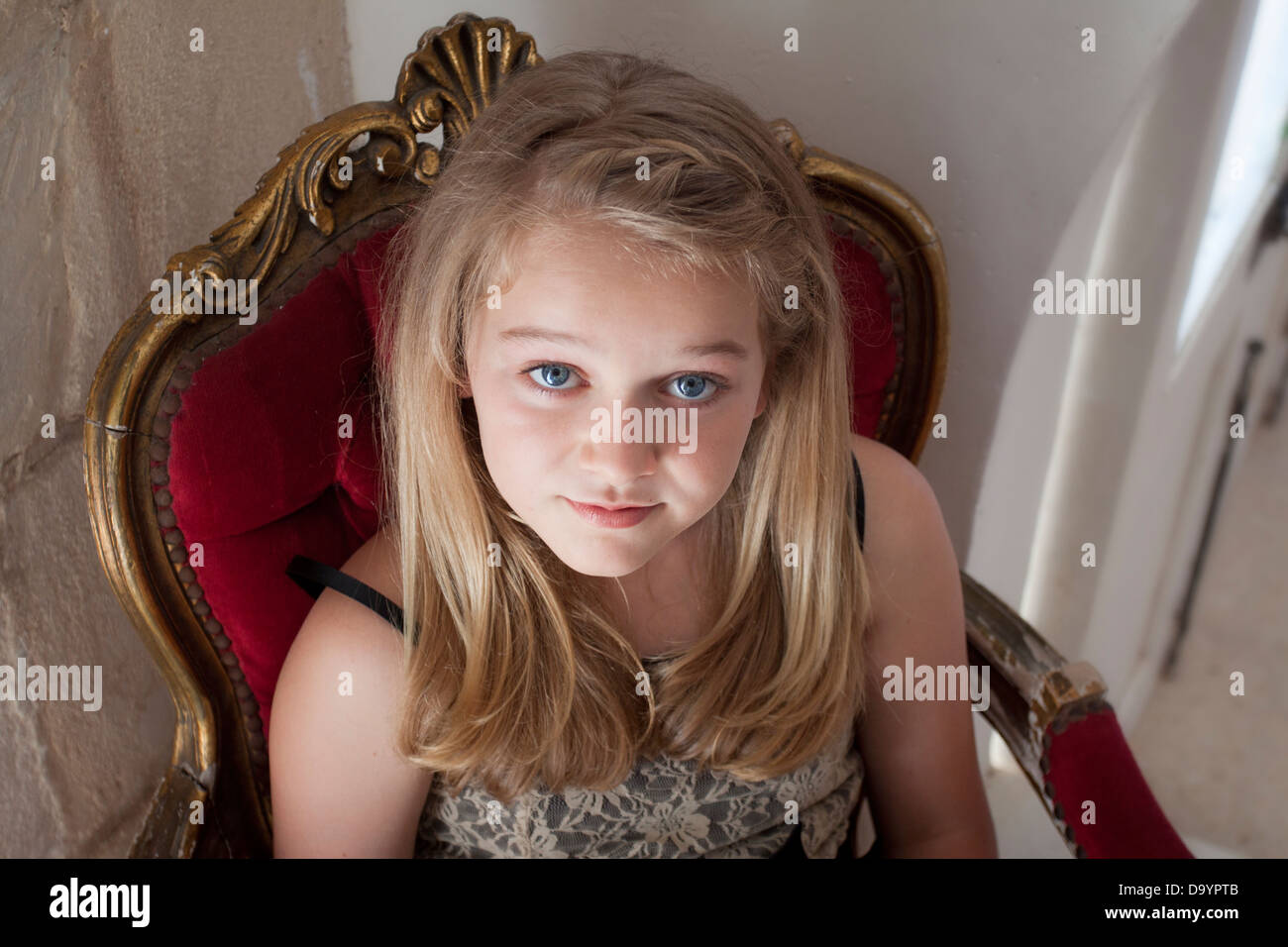 A stunning young lady dressed up for a ball, waiting for her date Stock Photo
