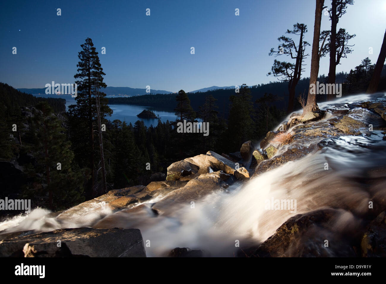Eagle Falls is illuminated at night with Emerald Bay and Lake Tahoe in the background in Lake Tahoe, CA. Stock Photo