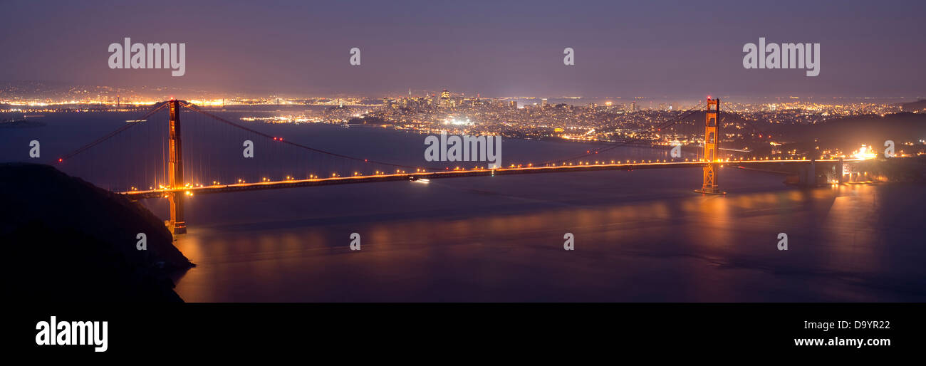 A panorama of the Golden Gate Bridge at night with San Francisco in the background, CA. Stock Photo