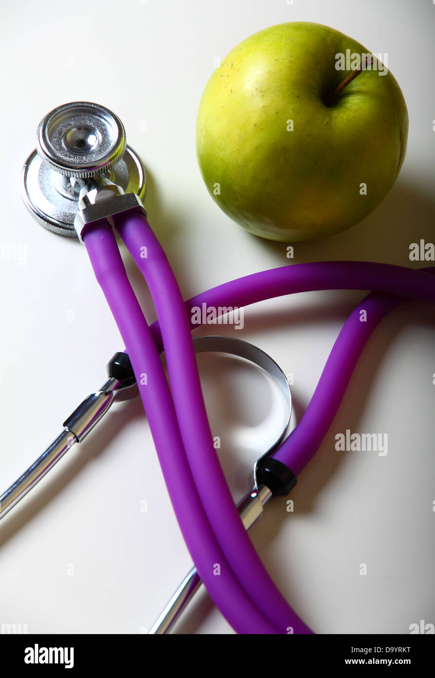 Apple and stethoscope on white background Stock Photo