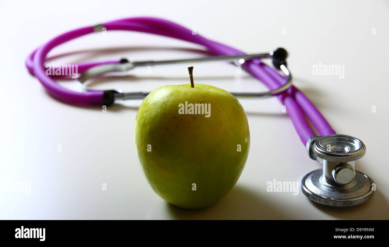 Apple and stethoscope on white background Stock Photo