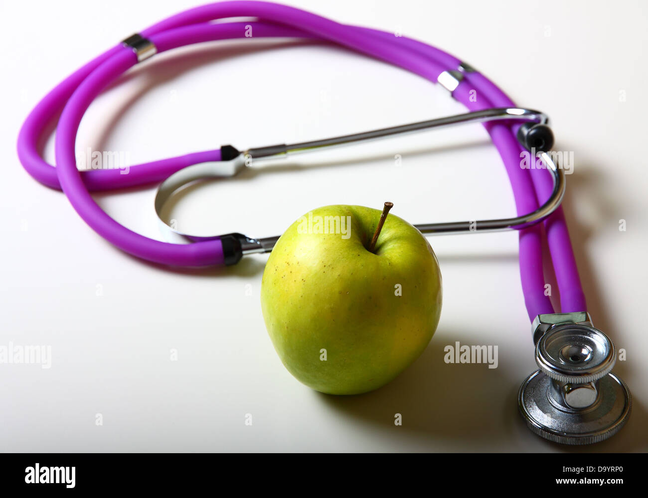 Apple and stethoscope on white background Stock Photo Alamy