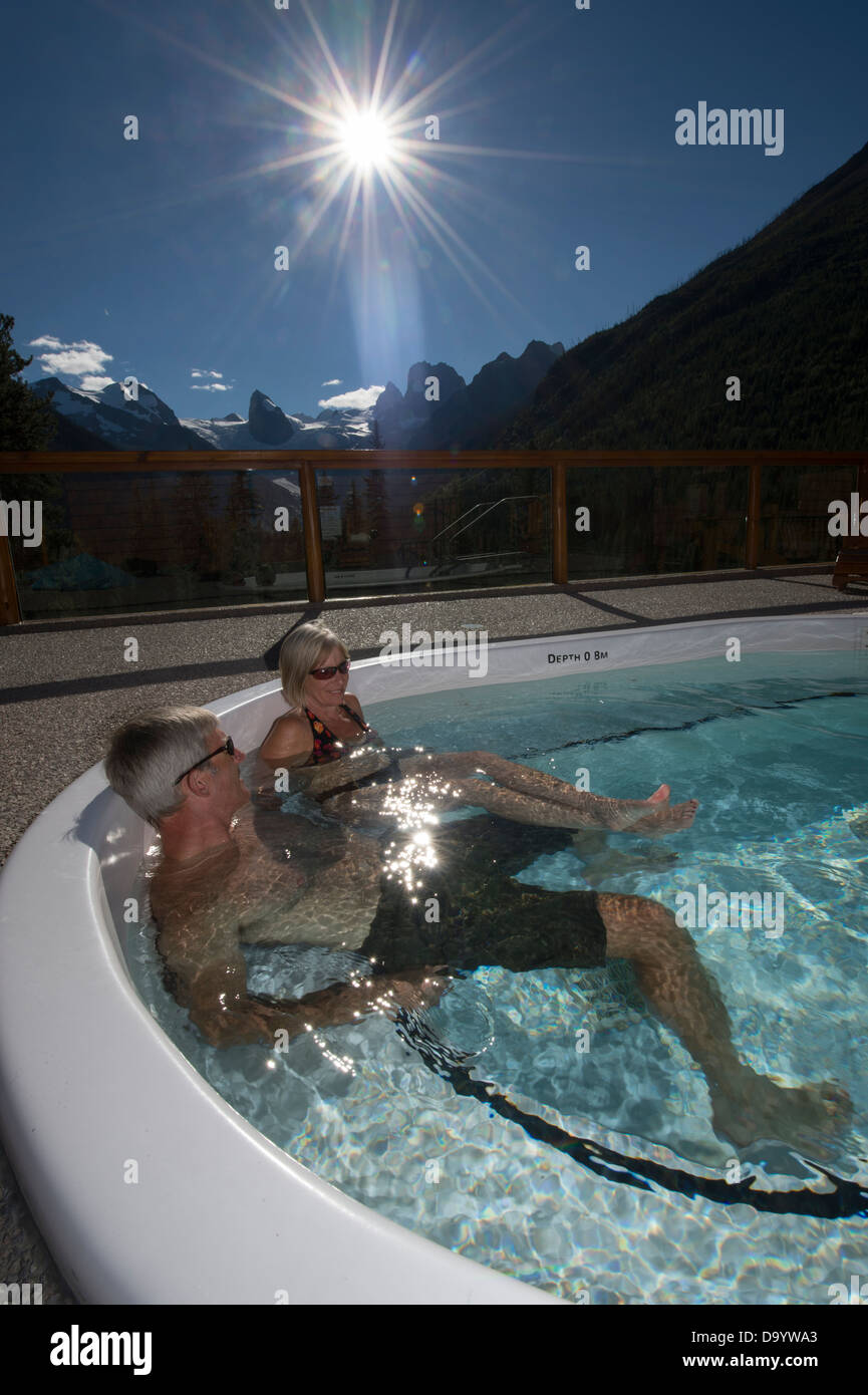 Couple enjoys a scenic hot tub after a day of hiking. Stock Photo