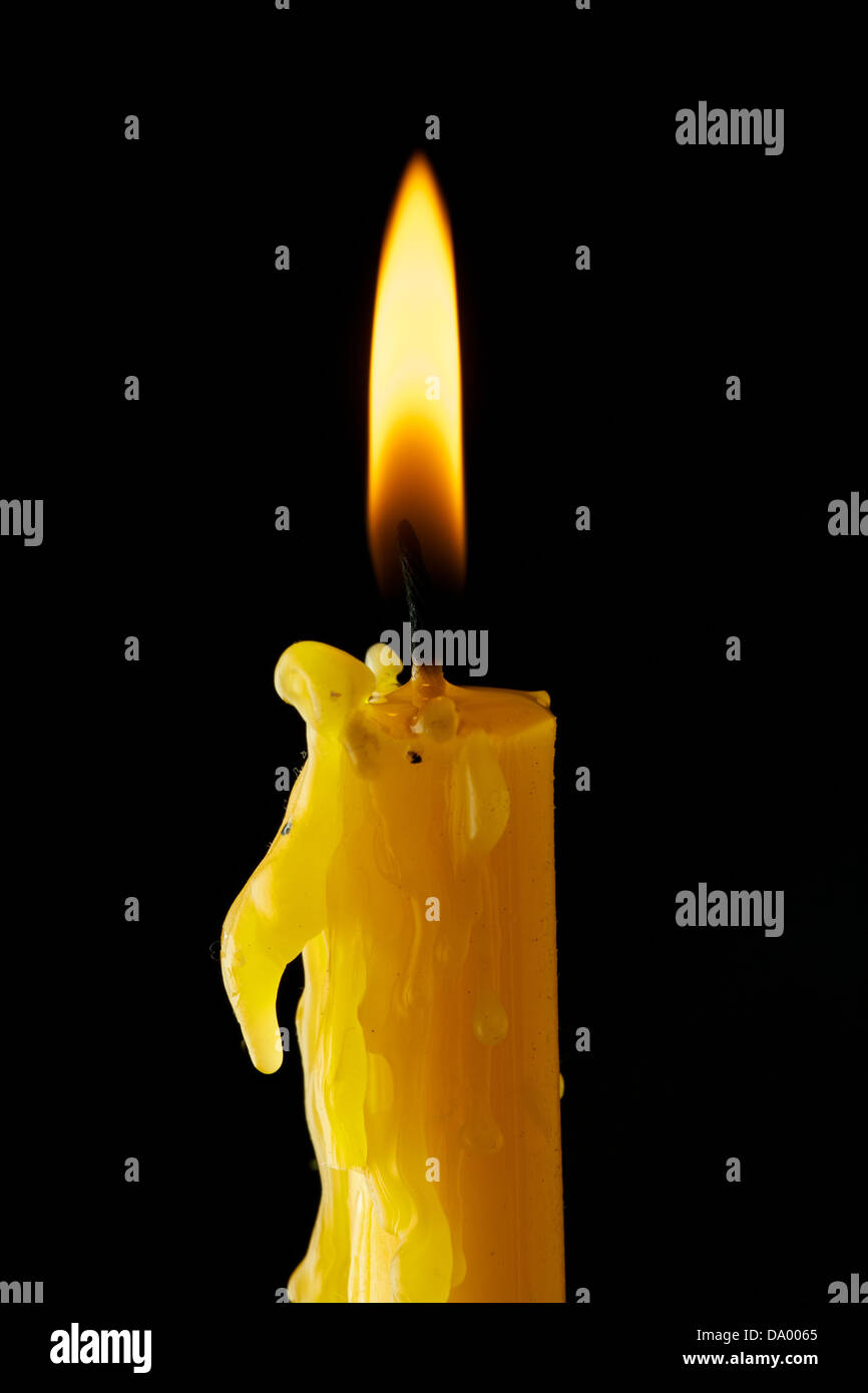 Single lit candle with quite flame Stock Photo Alamy