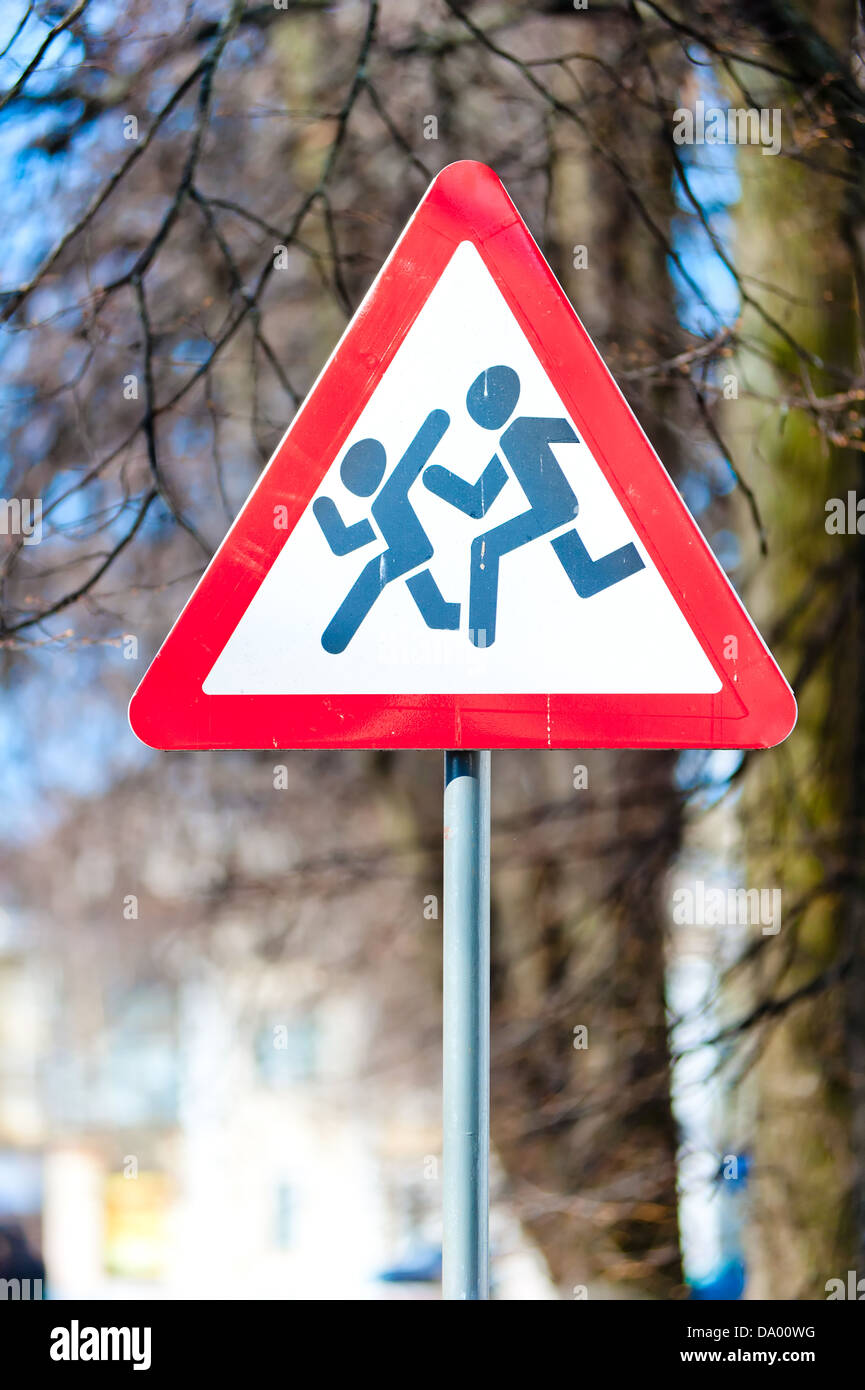 Warning road s Sign kids installed on sections of roads where possible sudden appearance of childrenign - Caution children! Stock Photo