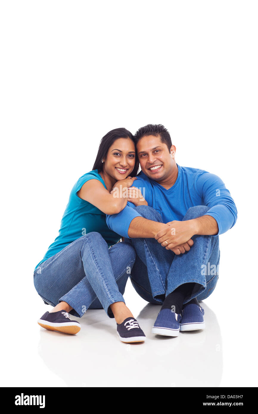 cute young indian couple sitting on the floor isolated on white Stock ...