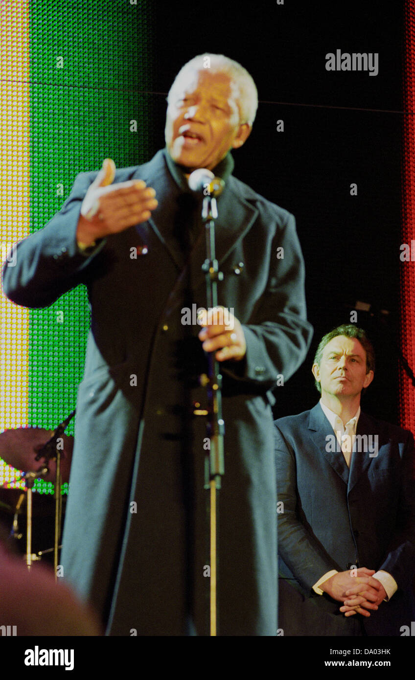 Nelson Mandela speaks with Tony Blair looking on at the Celebrate South Africa concert in Trafalgar Square, London, UK. Stock Photo
