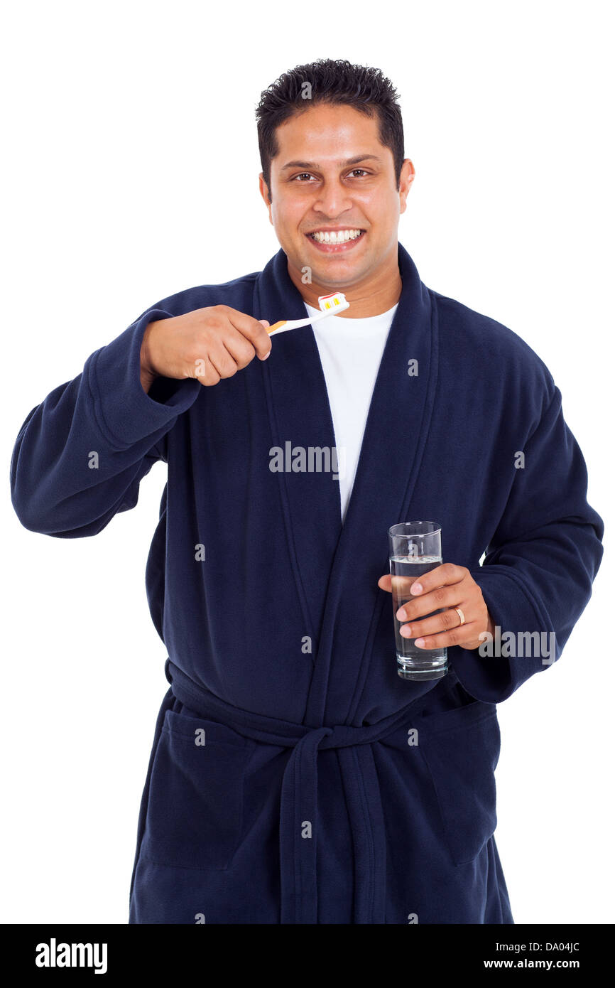 handsome indian man brushing teeth in pajamas isolated on white Stock