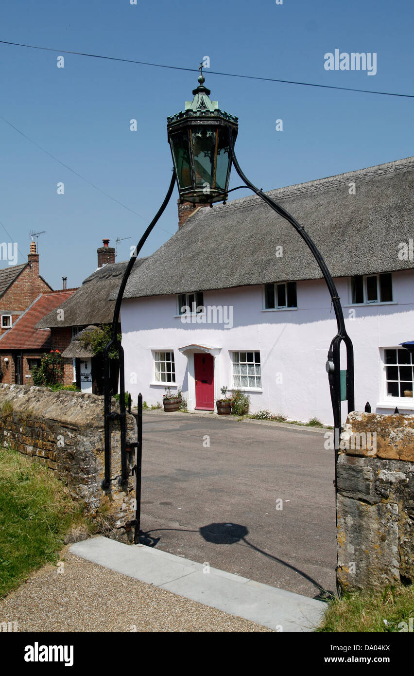thatched cottage from Lych Gate Puddletown Thomas Hardy's Weatherbury Dorset England UK Stock Photo