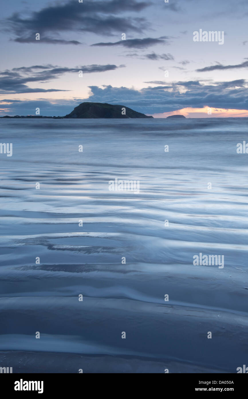 Sunset over Uphill Beach with Brean Down visible on the horizon. North Somerset, UK. Stock Photo