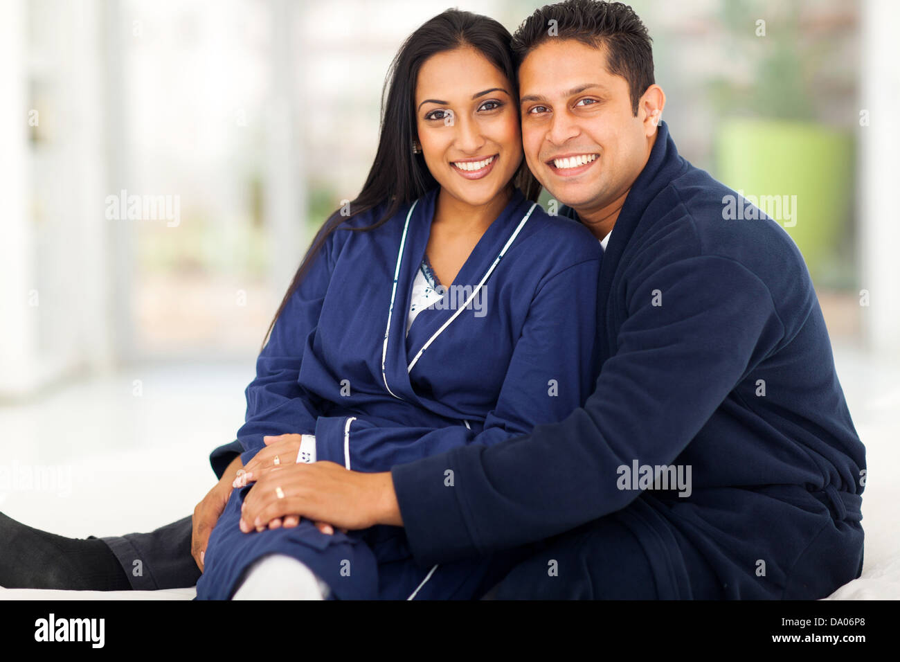 beautiful loving indian couple sitting in bedroom Stock Photo