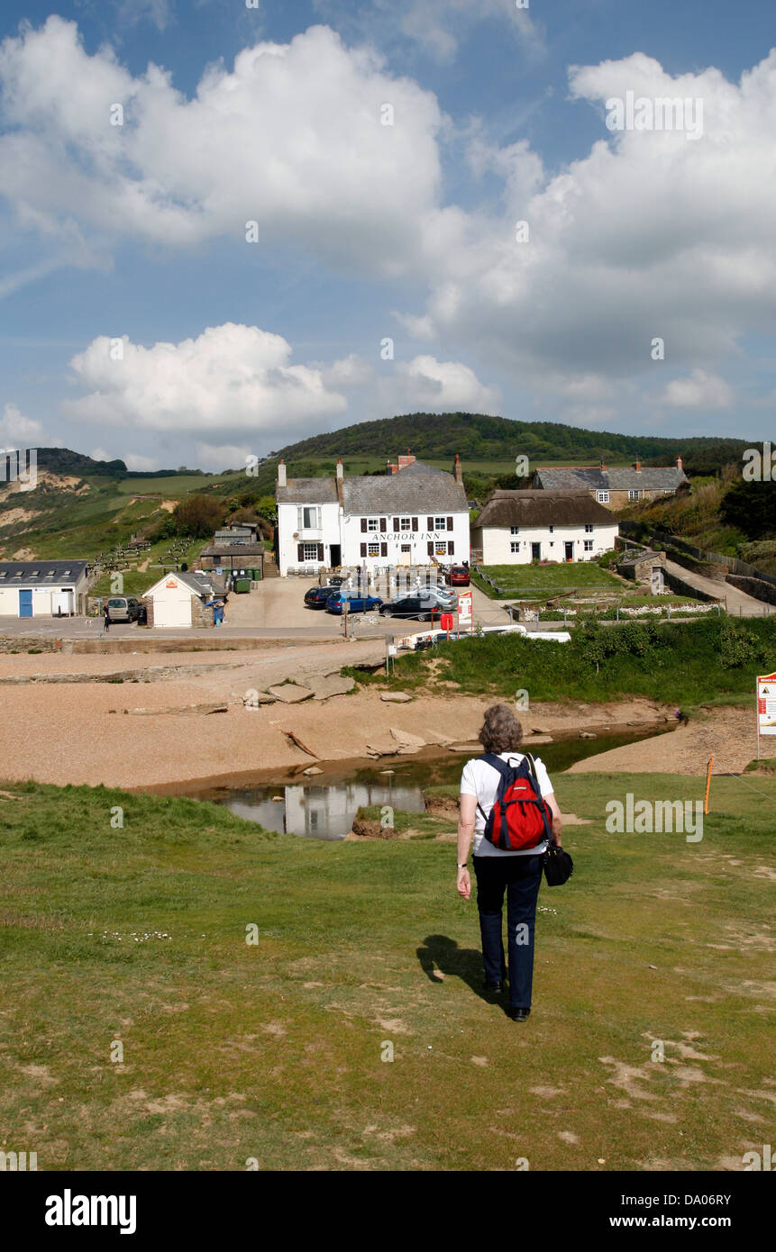 Jurassic Coast walker and Anchor Inn Seatown Dorset England UK c Stock