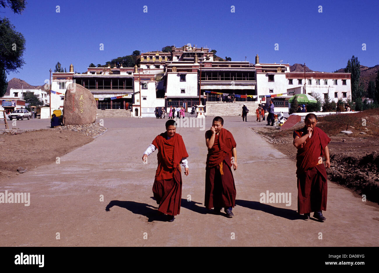 Buddhists monks going out from Badekar Monastery known as Wudang zhao Temple the largest and best-preserved Tibetan Buddhist Lamasery of the Gelug sect built  in 1749 in the no Han-style architecture located about 70 kilometres northeast of Baotou in Inner Mongolia Autonomous Region. China Stock Photo