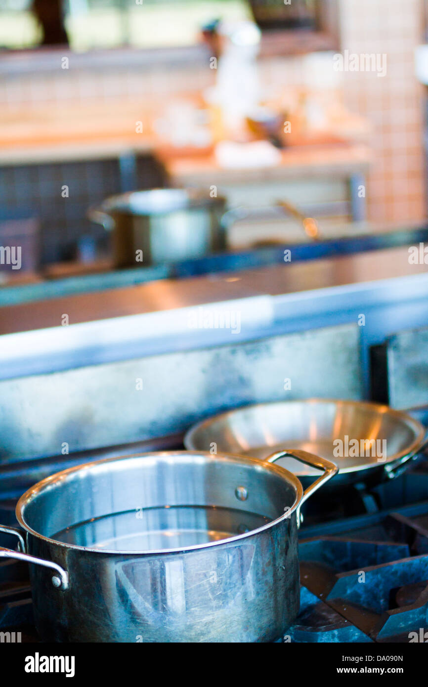 Cooking pots and pans on a gas stove Stock Photo - Alamy